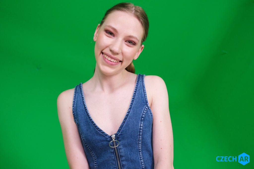 Maya Sinn AR pornstar clothed smiling.